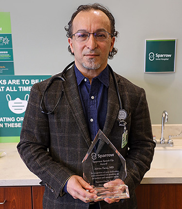 Dr. Adriss Faraj Holds Speak Up Award Dr. Adriss Faraj Holds Speak Up Award