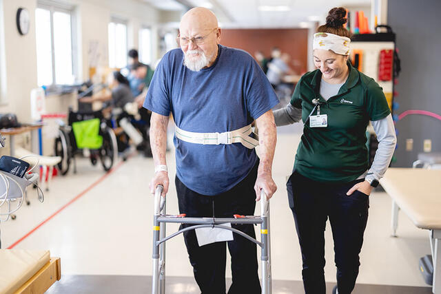 Mary Free Bed Carousel - Older Man with Walker and Physical Therapist Mary Free Bed Carousel - Older Man with Walker and Physical Therapist
