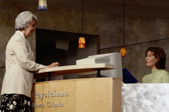 Women at front desk speaking with female receptionist