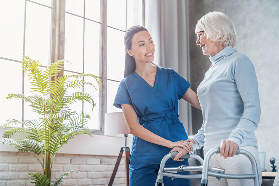 Caregiver with patient using walker