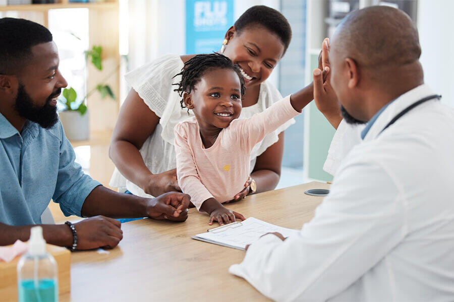 A young girl gives the doctor a high five